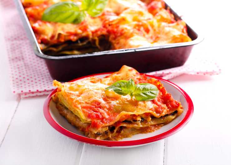 teglia e fetta di lasagne alla norma